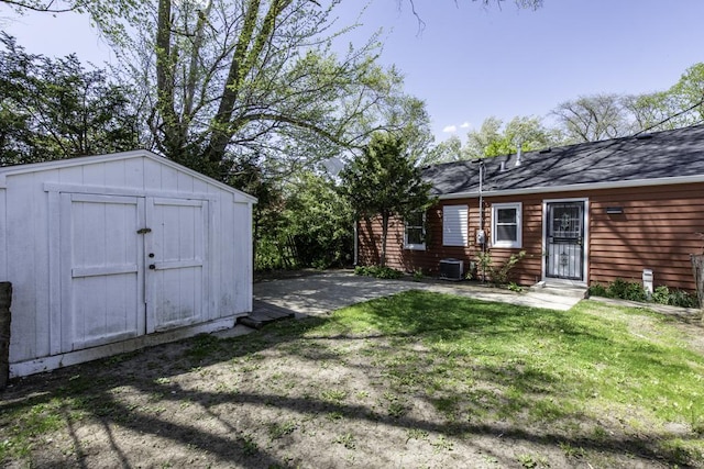 1705 Lyons Ct, Waukegan, IL 60085 - view of green lawn featuring a shed, cooling unit, and an outdoor structure