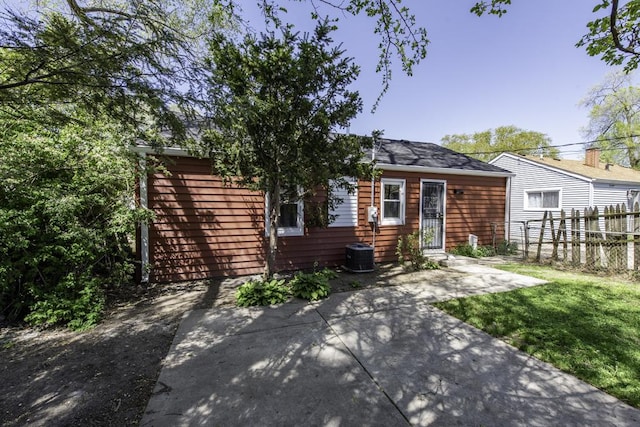 1705 Lyons Ct, Waukegan, IL 60085 - view of front of house with fence, central air condition unit, and a patio