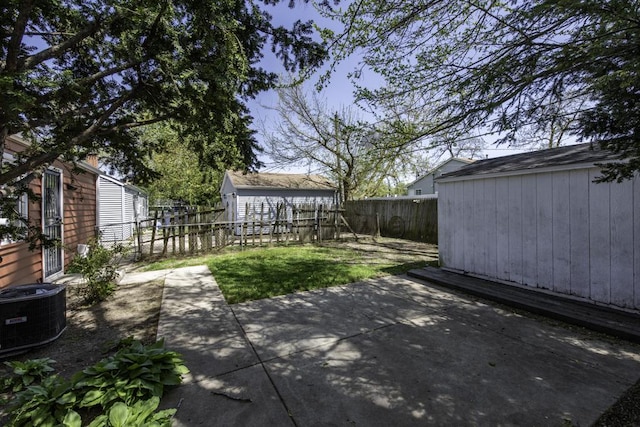 1705 Lyons Ct, Waukegan, IL 60085 - view of patio featuring a shed, central AC, a fenced backyard, and an outdoor structure
