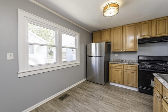1705 Lyons Ct, Waukegan, IL 60085 - kitchen with freestanding refrigerator, black gas range, under cabinet range hood, ornamental molding, and light wood-style flooring