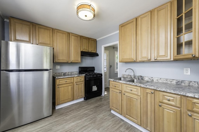 1705 Lyons Ct, Waukegan, IL 60085 - kitchen with freestanding refrigerator, black gas range oven, under cabinet range hood, a sink, and light wood-type flooring