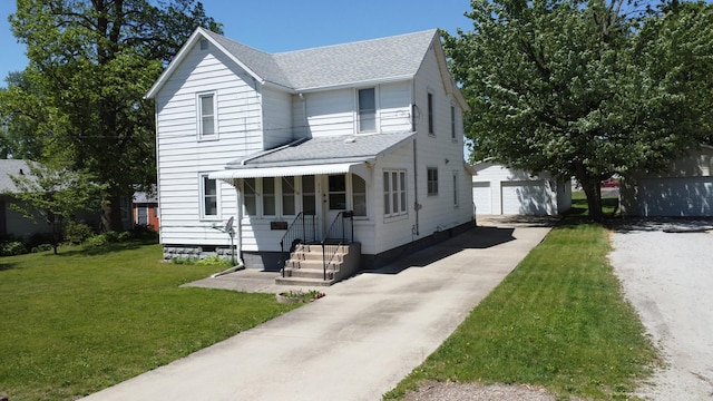 218 W Fleming St, Watseka, IL 60970 - view of front facade with a shingled roof, an outbuilding, and a front lawn