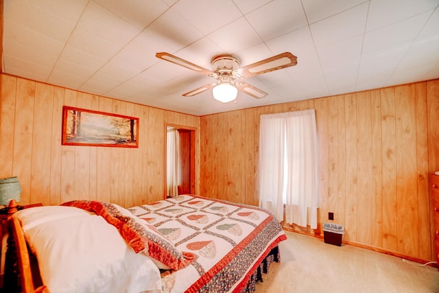 218 W Fleming St, Watseka, IL 60970 - bedroom featuring carpet, wood walls, and a ceiling fan