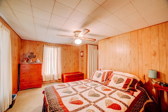 218 W Fleming St, Watseka, IL 60970 - carpeted bedroom with wooden walls and ceiling fan