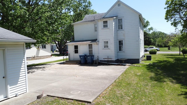 218 W Fleming St, Watseka, IL 60970 - back of house with a lawn, central AC unit, a patio area, and a shingled roof