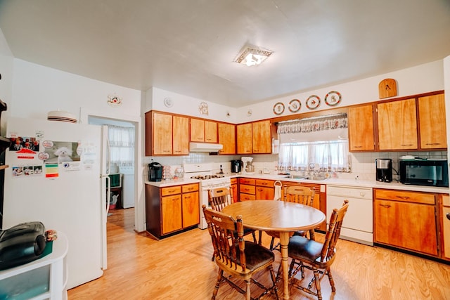 218 W Fleming St, Watseka, IL 60970 - kitchen featuring white appliances, under cabinet range hood, a sink, light wood-type flooring, and light countertops