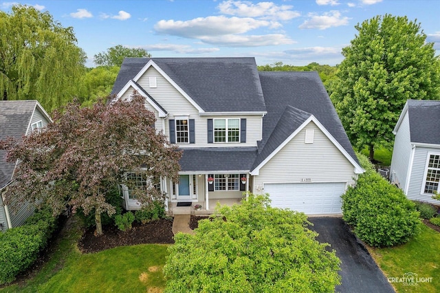 S970 Newton Sq, Geneva, IL 60134 - traditional-style home featuring driveway, a garage, roof with shingles, and a porch