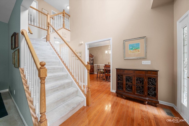 S970 Newton Sq, Geneva, IL 60134 - entryway featuring hardwood / wood-style floors, stairway, baseboards, and a towering ceiling