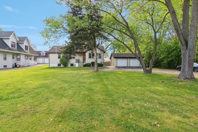 35790 N Wilson Rd, Ingleside, IL 60041 - view of grassy yard with an outbuilding, a detached garage, and asphalt driveway