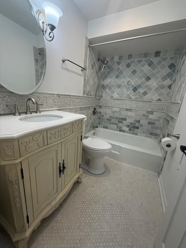 6436 W 64th Pl Unit A3, Chicago, IL 60638 - bathroom featuring shower / bath combination, toilet, vanity, tile walls, and wainscoting