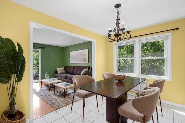 6436 W 64th Pl Unit A3, Chicago, IL 60638 - dining room with a chandelier, baseboards, and light tile patterned flooring