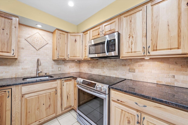 6436 W 64th Pl Unit A3, Chicago, IL 60638 - kitchen featuring appliances with stainless steel finishes, a sink, light brown cabinets, light tile patterned flooring, and tasteful backsplash