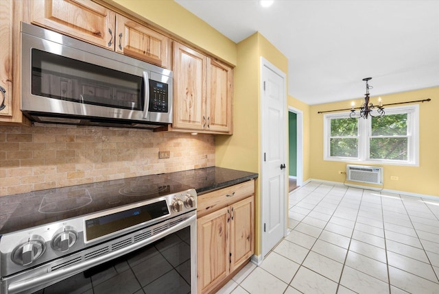 6436 W 64th Pl Unit A3, Chicago, IL 60638 - kitchen featuring appliances with stainless steel finishes, a wall mounted air conditioner, a chandelier, dark countertops, and backsplash