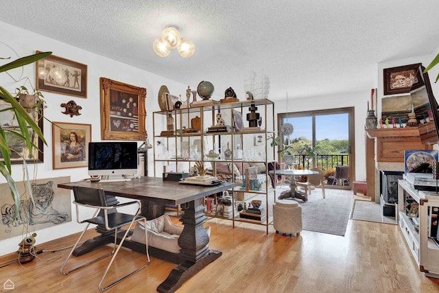 724 12th St Unit 303, Wilmette, IL 60091 - office with wood finished floors, a textured ceiling, and a fireplace