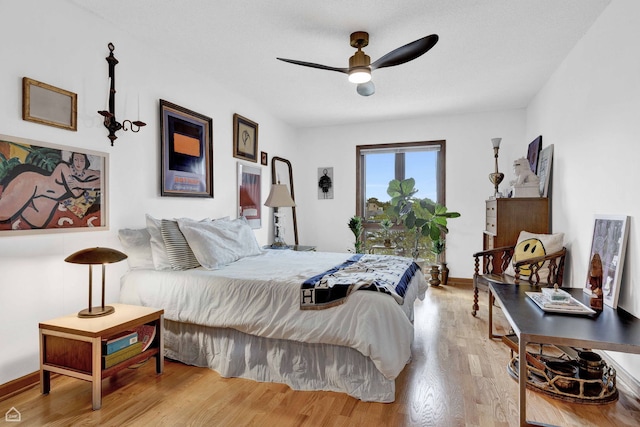 724 12th St Unit 303, Wilmette, IL 60091 - bedroom featuring wood finished floors, a ceiling fan, and baseboards