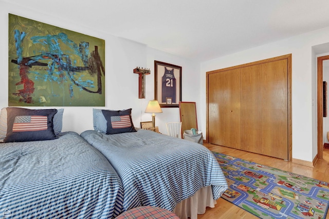 724 12th St Unit 303, Wilmette, IL 60091 - bedroom featuring a closet, light wood-style floors, and baseboards