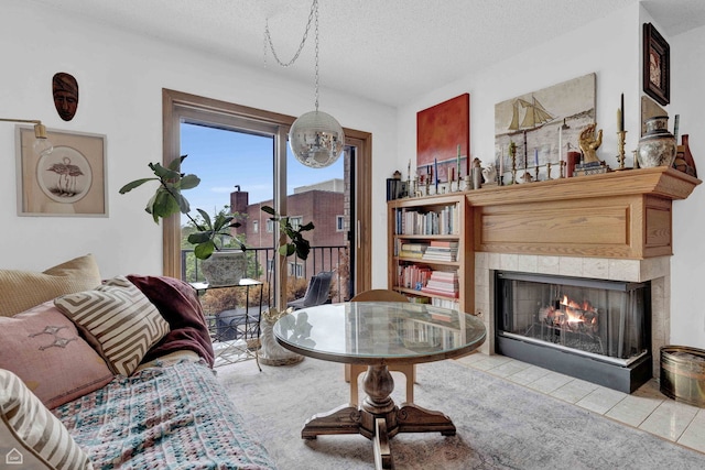 724 12th St Unit 303, Wilmette, IL 60091 - living area featuring a tiled fireplace and a textured ceiling