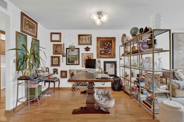 724 12th St Unit 303, Wilmette, IL 60091 - office area with wood finished floors, a textured ceiling, a chandelier, and baseboards