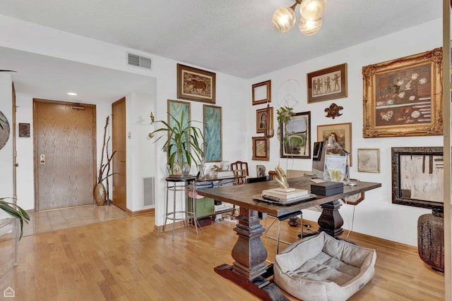 724 12th St Unit 303, Wilmette, IL 60091 - office space featuring light wood-style flooring, baseboards, and a textured ceiling