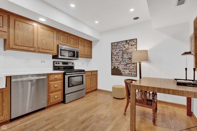 724 12th St Unit 303, Wilmette, IL 60091 - kitchen with stainless steel appliances, light wood-type flooring, recessed lighting, baseboards, and brown cabinetry