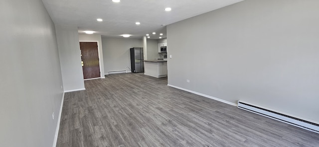 802 E Old Willow Rd Unit 2-210, Prospect Heights, IL 60070 - unfurnished living room with baseboard heating, recessed lighting, wood finished floors, and baseboards