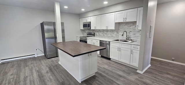 802 E Old Willow Rd Unit 2-210, Prospect Heights, IL 60070 - kitchen with stainless steel appliances, a sink, dark wood finished floors, a baseboard radiator, and backsplash