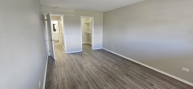 802 E Old Willow Rd Unit 2-210, Prospect Heights, IL 60070 - unfurnished bedroom featuring baseboards, a spacious closet, dark wood-style flooring, and a closet