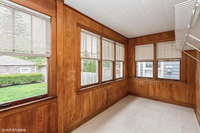 5000 N Kenneth Ave, Chicago, IL 60630 - unfurnished sunroom featuring wood walls, baseboards, and tile patterned floors
