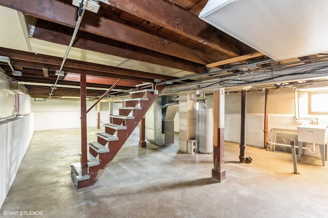 5000 N Kenneth Ave, Chicago, IL 60630 - unfinished below grade area with gas water heater, stairway, and heating unit