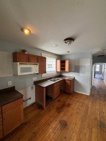 8370 S Baker Ave, Chicago, IL 60617 - kitchen with white microwave, dark wood-style floors, and brown cabinets