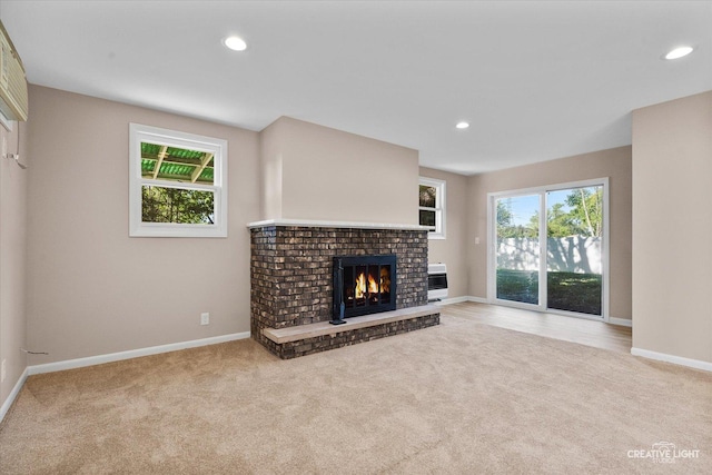304 John St, North Aurora, IL 60542 - unfurnished living room featuring light carpet, a brick fireplace, baseboards, and recessed lighting