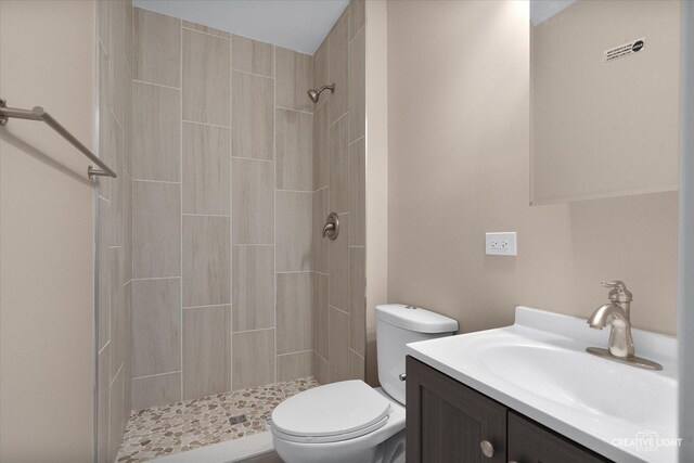 304 John St, North Aurora, IL 60542 - bathroom featuring tiled shower, toilet, and vanity
