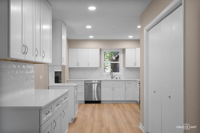 304 John St, North Aurora, IL 60542 - kitchen featuring dishwasher, a sink, recessed lighting, tasteful backsplash, and white cabinetry