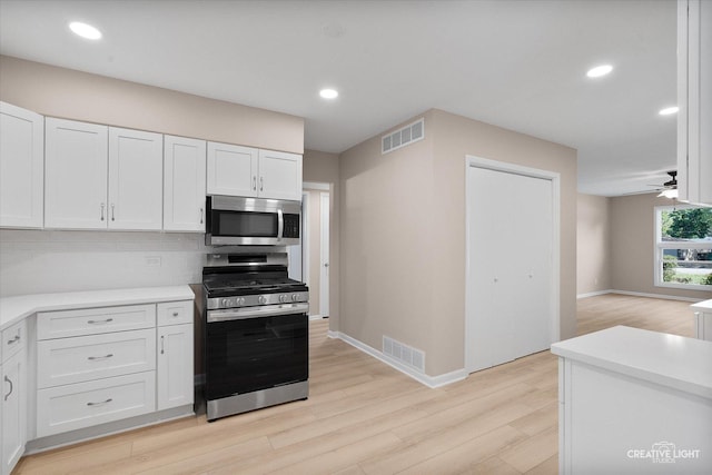 304 John St, North Aurora, IL 60542 - kitchen with stainless steel appliances, light wood finished floors, white cabinets, light countertops, and recessed lighting
