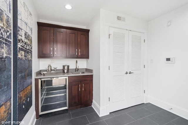 3737 N Clifton Ave Unit 3, Chicago, IL 60613 - indoor wet bar featuring beverage cooler, dark tile patterned floors, baseboards, and recessed lighting