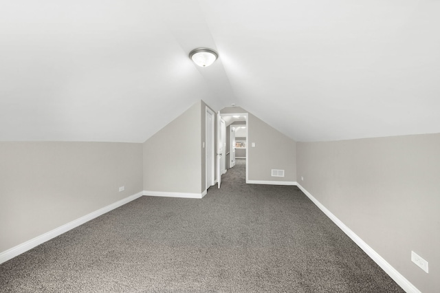 9028 S Ada St, Chicago, IL 60620 - bonus room featuring dark colored carpet, lofted ceiling, and baseboards