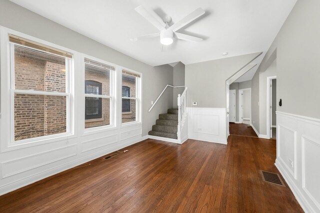 9028 S Ada St, Chicago, IL 60620 - empty room with wood-type flooring, stairs, wainscoting, ceiling fan, and a decorative wall