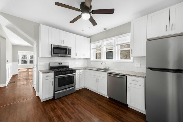 9028 S Ada St, Chicago, IL 60620 - kitchen featuring appliances with stainless steel finishes, a sink, white cabinetry, and wainscoting