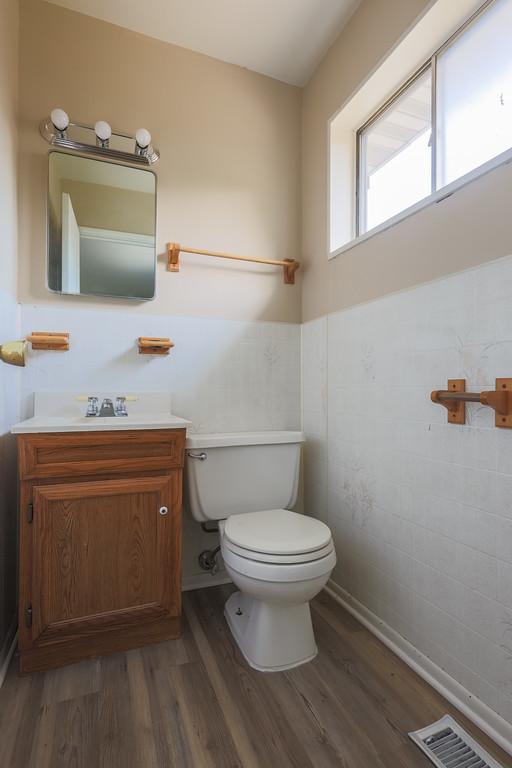 885 163rd St, Calumet City, IL 60409 - half bathroom with wood finished floors, toilet, vanity, and tile walls