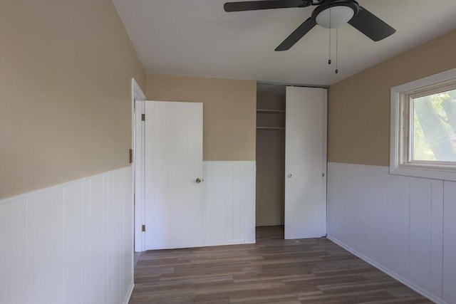 885 163rd St, Calumet City, IL 60409 - unfurnished bedroom featuring a wainscoted wall, wood finished floors, a closet, and a ceiling fan