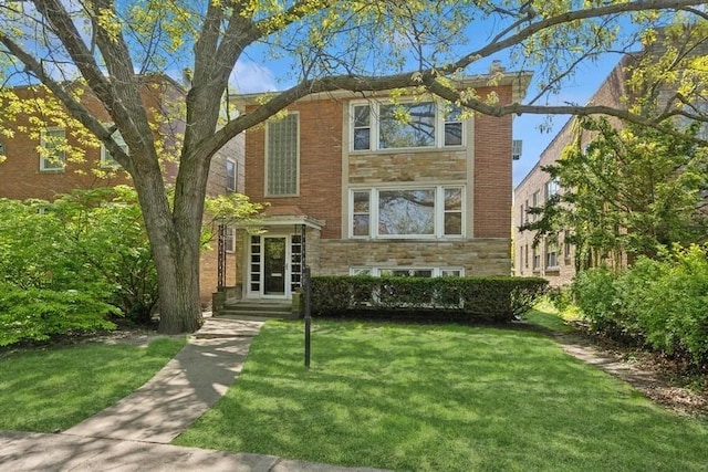 1214 Hull Ter, Evanston, IL 60202 - view of front facade featuring a front yard, stone siding, and brick siding
