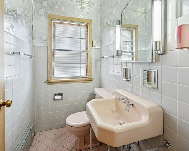 1214 Hull Ter, Evanston, IL 60202 - half bath with tile walls, a sink, toilet, tile patterned flooring, and baseboard heating