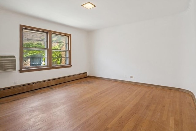 1214 Hull Ter, Evanston, IL 60202 - spare room featuring baseboard heating, wood finished floors, and a wall mounted AC