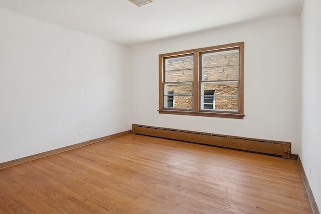 1214 Hull Ter, Evanston, IL 60202 - empty room with baseboard heating, light wood-style floors, and baseboards
