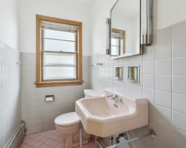 1214 Hull Ter, Evanston, IL 60202 - bathroom featuring a baseboard heating unit, tile walls, healthy amount of natural light, toilet, and a sink