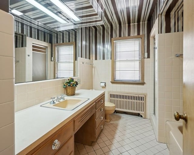 1214 Hull Ter, Evanston, IL 60202 - full bath featuring radiator, healthy amount of natural light, tile patterned flooring, an enclosed shower, and tile walls