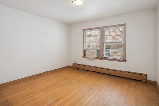 1214 Hull Ter, Evanston, IL 60202 - unfurnished room featuring baseboard heating, light wood-style floors, crown molding, and baseboards