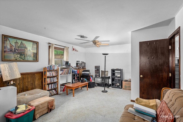 859 N Gladstone Ave, Aurora, IL 60506 - living area with carpet, a ceiling fan, a wainscoted wall, and wood walls