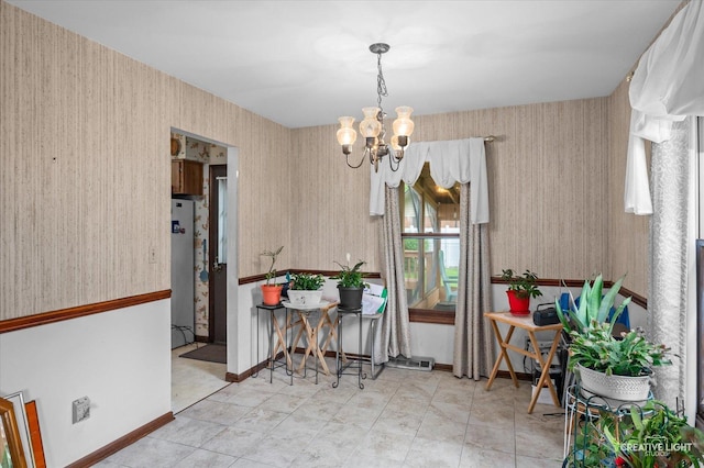 859 N Gladstone Ave, Aurora, IL 60506 - dining space featuring a chandelier, wallpapered walls, and baseboards