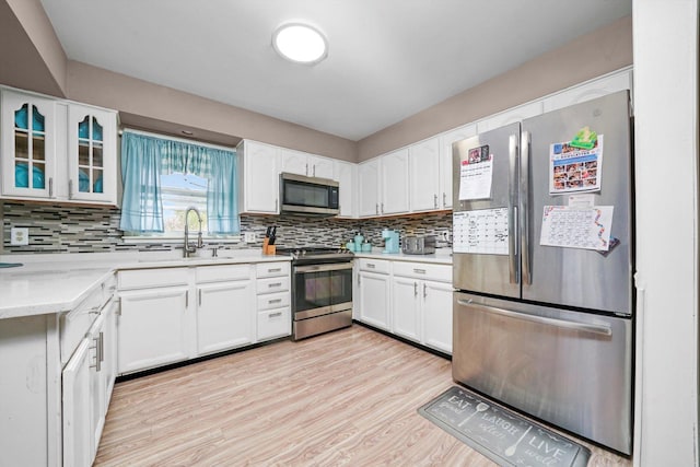 1191 Comet Dr, Aurora, IL 60505 - kitchen featuring appliances with stainless steel finishes, a sink, tasteful backsplash, and white cabinets